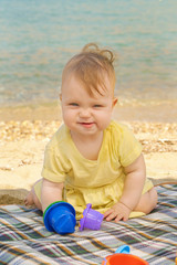 Happy baby playing on the beach