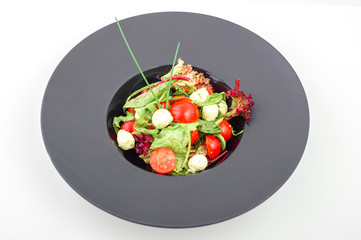 caprese salad with mini mozzarella balls and tomatoes, close up photo