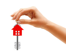 Woman's hand holding key to the apartment isolated on white background