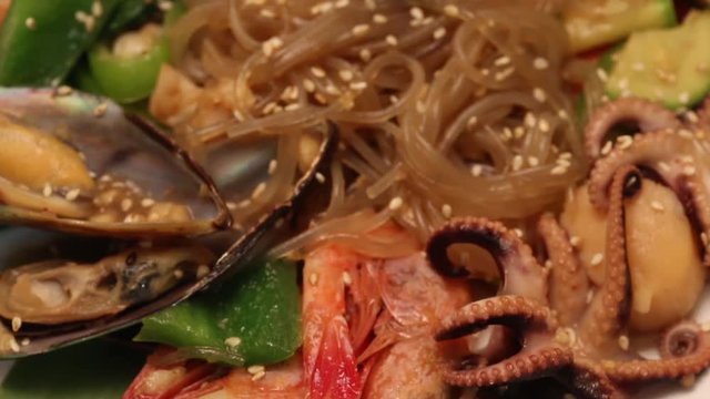 Fried seafood with vegetables and glass noodles. Food Korean cuisine