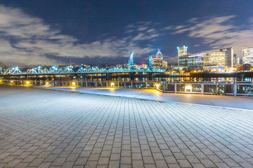 empty brick floor with cityscape and skyline of portland at nigh