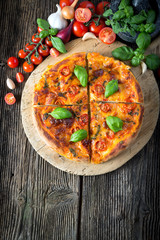 homemade pizza margherita with mozzarella, basil and tomatoes