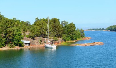 Fototapeta na wymiar White yacht in the blue lagoon. Aland Islands
