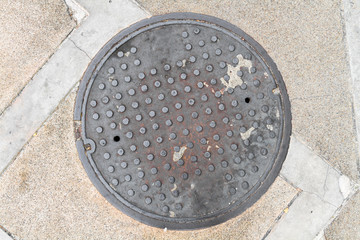 Rusty, grunge manhole cover in original background, NOT isolated