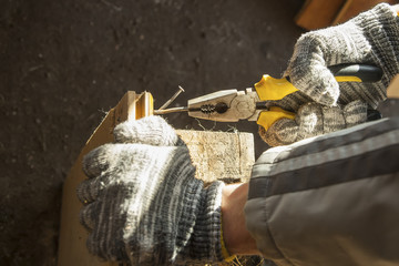 Locking Pliers in hand. Joinery, workshop