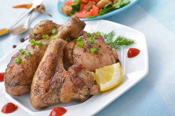 Roast chicken with lemon on a white plate