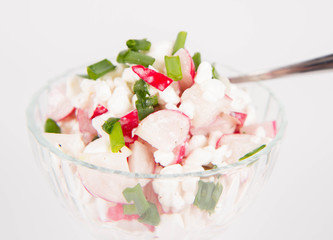 Cottage cheese with radish and chives in a cup