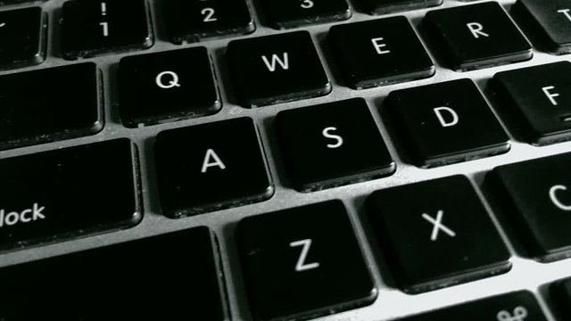 Closeup dolly of the letters on a laptop keyboard.