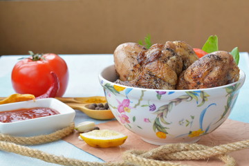 Bowl with grilled chicken wings and legs