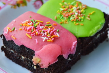 chocolate cake top colorful crispy sugar on dish