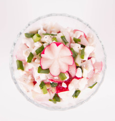 Cottage cheese with radish and chives in a cup