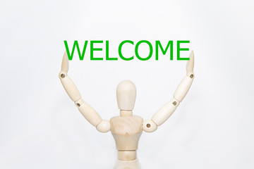 Hand writing welcome with wooden persona. isolated on white