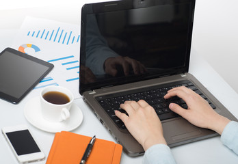 Businessman sitting in front of computer monitor and analyzing data