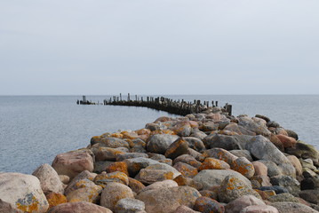 Fototapeta na wymiar Breakwater (pier). The construction of a wall in the port or at the entrance to the port to protect the ships from sea waves.