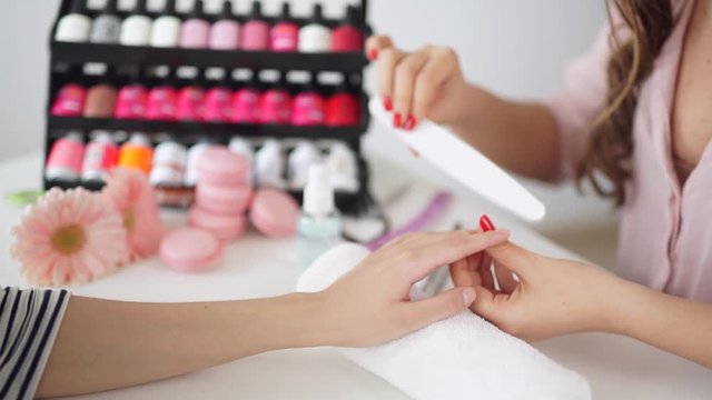 Manicure process in beauty salon, close up
