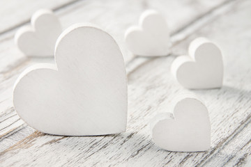 White hearts and wooden background