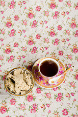 A cup of tea and saucer with delicious halva