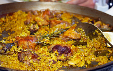 Paella with chicken meat and vegetables