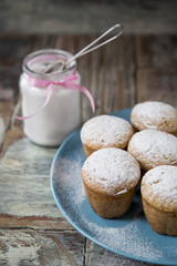 Freshly baked homemade muffins with powdered sugar