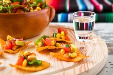 Close up of nachos chips and tequila