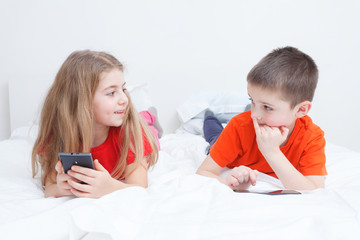 kids playing in bed with smart-phone