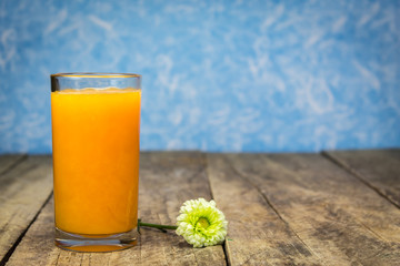 Fresh orange juice on wooden table