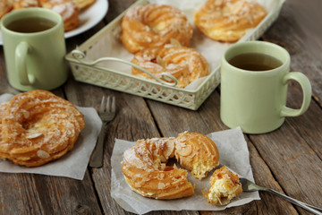 Sweet eclairs on a grey wooden table