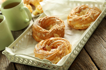 Sweet eclairs on a grey wooden table
