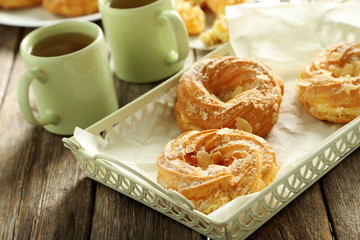 Sweet eclairs on a grey wooden table