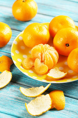 Ripe mandarins on a blue wooden table