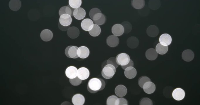 Abstract Bokeh Of White Circles Of Sun Glare Reflection Over Water