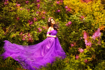 Obraz na płótnie Canvas Beautiful young woman in purple flowers