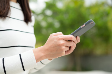 Woman using cellphone at outdoor park