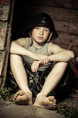 Calm little boy in helmet sitting in cabin