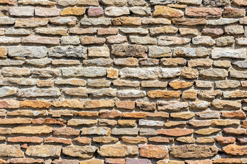 Fototapeta premium Brown masonry rock wall
