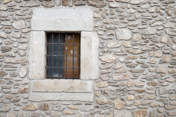 Old stones wall background with a window