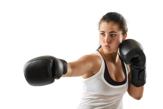 Boxer woman during boxing exercise making direct hit in black gloves