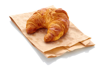 fresh croissant with paper bag on white background