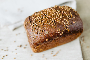 Black bread with fresh coriander closeup