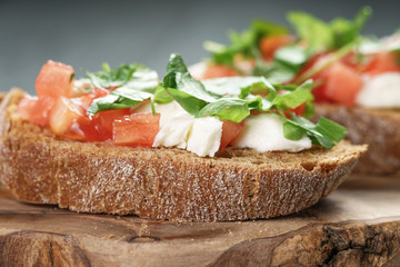 homemade bruschetta with cheese and vegetables, shallow focus