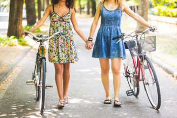 Two girls walking on the street holding hands