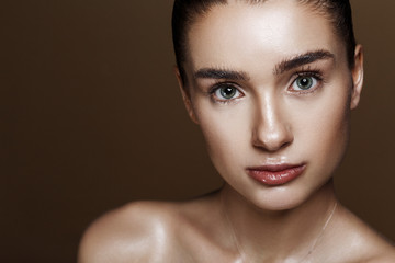 Strobing or Highlighting makeup. Closeup portrait of beautiful girl with strobing highlighter...