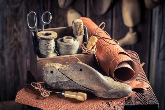 Small shoemaker workshop with shoes, laces and tools