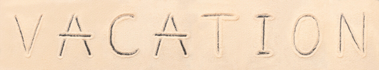 Vacation lettering drawn on sand