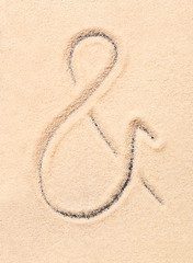 Ampersand symbol drawn on sand