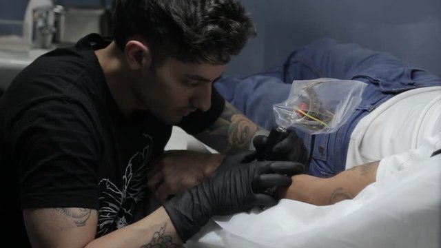 Artist preparing a tattoo on clients arm