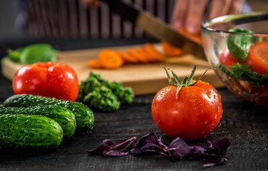 Male hands cutting vegetables for salad