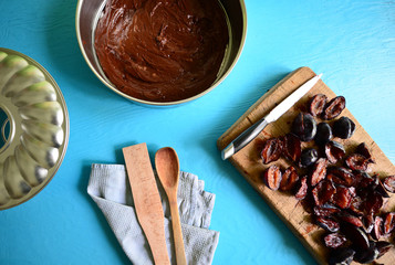 Preparing chocolate cake with plums