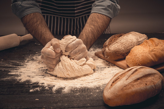 Male Hands Knead The Dough.