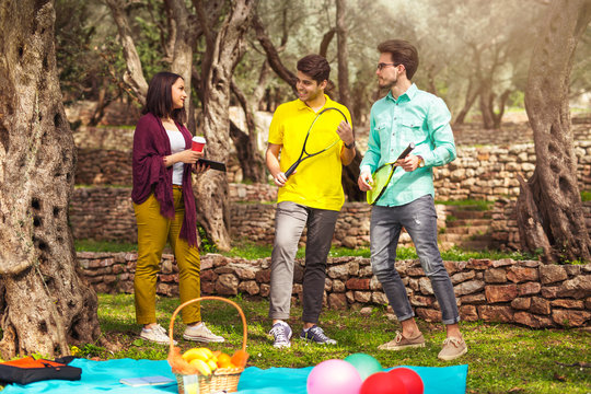 Three young people playing speedminton - badminton